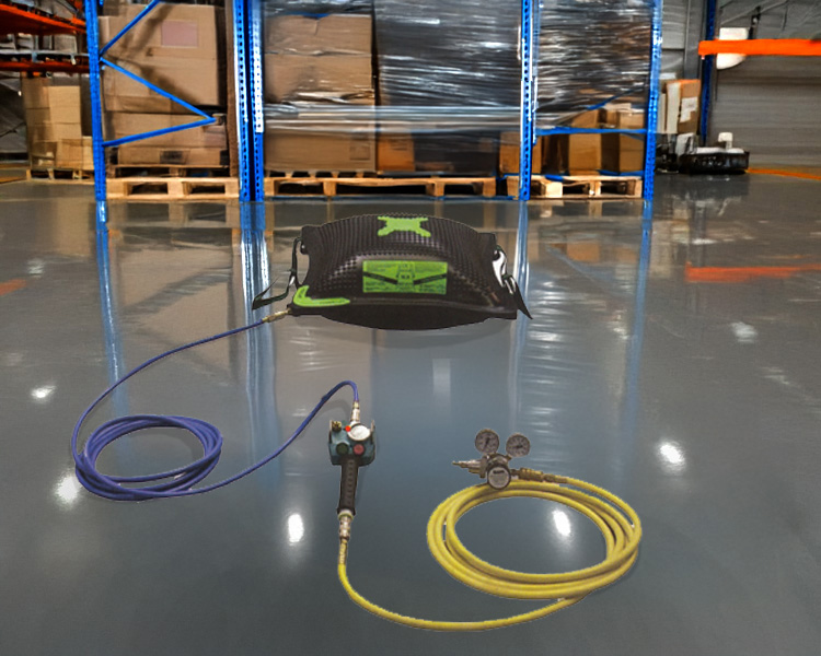 A construction worker wearing a hard hat, safety vest, and tool belt stands confidently next to a yellow featherlite ladder in a bright indoor setting.